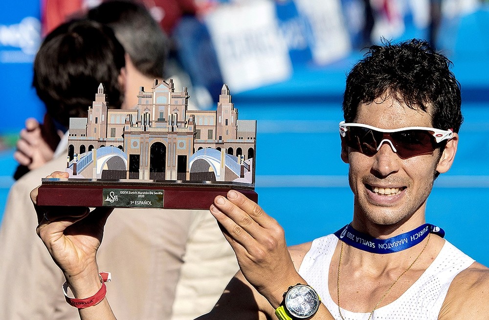 Javi Guerra muestra el trofeo al mejor español en la Maratón de Sevilla.
