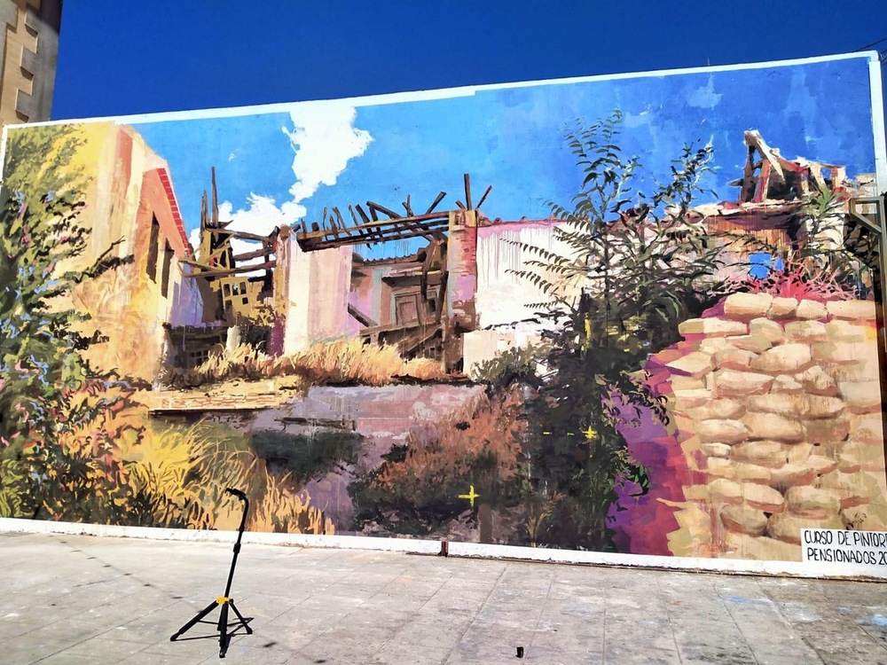 El mural recoge el paisaje de uno de los lugares donde han pintado este verano los catorce estudiantes de Bellas Artes seleccionados. 